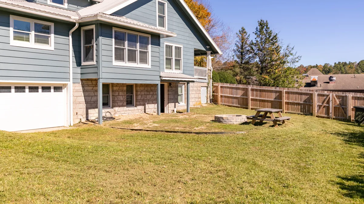 This image spotlights the backyard’s picnic table, fire pit, and fenced boundaries. The peaceful setting and ample space are ideal for family picnics, casual barbecues, and relaxing evenings, emphasizing both pet safety and memorable outdoor moments.