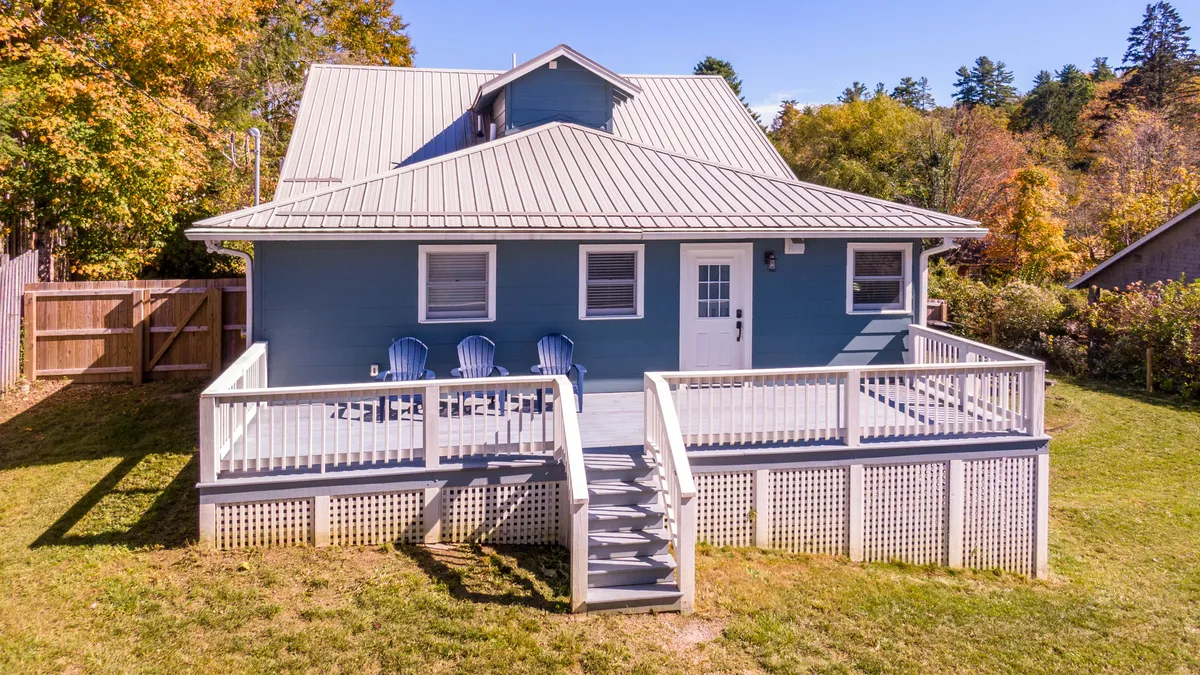 A comfortable outdoor deck with ample seating, offering views of the surrounding greenery. The setup suggests a seamless transition from indoor comfort to outdoor enjoyment, perfect for relaxing or entertaining guests.
